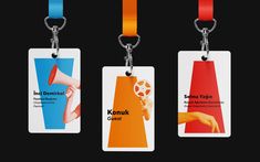 three tags with different colors and designs hanging from metal hooks on a black background that says konkuk center