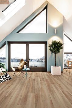 a living room with wooden floors and skylights