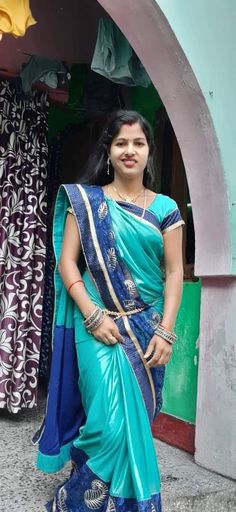 a woman in a blue sari posing for the camera