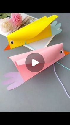 two paper birds sitting next to each other