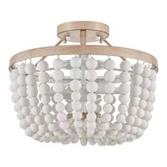 a chandelier with white balls hanging from it's wooden frame and light fixture