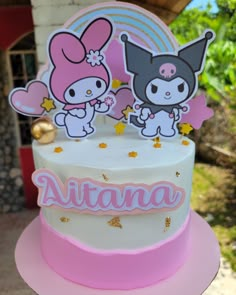 a white and pink cake with two cartoon characters on it