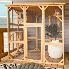 a large wooden bird cage sitting on top of a floor