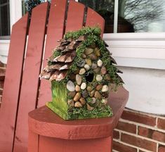 a bird house sitting on top of a red chair