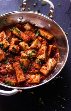 a pan filled with tofu and sauce on top of a table