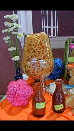 the table is covered with different types of pasta and wine glasses, flowers, and other items