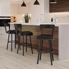 three bar stools in front of a kitchen island