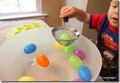 a young boy is playing with an easter egg decoration on a tray in his bedroom