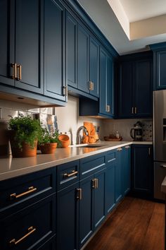 a kitchen with blue cabinets and gold pulls on the handles is seen in this image