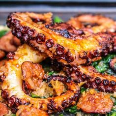 octopus bites are piled on top of spinach