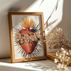 a heart with flowers in it sitting on a shelf