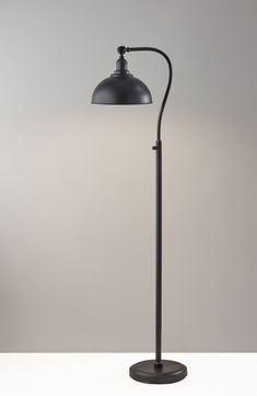 a black floor lamp on a white table