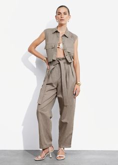 Trousers made from a linen-blend. Featuring a high paperbag waist and duo side pockets. • Relaxed fit • Duo welt pockets at the back • Belt loops • Zip fly with hook and bar closure • Length of inseam: 74cm / 29.1" (EU 36 / UK 8 / US 4) Paperbag Trousers, Knit Shoes, Clothing Essentials, Knit Sweater Dress, Fashion Story, High Waisted Trousers, Swimwear Fashion, Trouser Jeans, Scarf Hairstyles