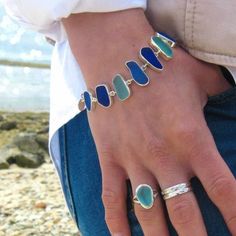 "CURRENTLY OUT OF STOCK IN SKY, BLUES and PASTEL - Please send us a message if you would like to be notified when these color combinations are back in stock! This elegant bracelet wonderfully showcases a selection of 9 pieces of authentic beach found sea glass each custom bezel set in sterling silver. Each piece of sea glass has been carefully preserved in sterling silver with an open back design to allow the light to shine through and highlight the gorgeous colors of the piece. The bracelet is Simple Leather Bracelet, Seaglass Jewelry, Beach Glass Necklace, Sea Glass Bracelet, Beach Necklaces, Wedding Jewelry Bracelets, Toggle Bracelet, Sea Glass Necklace, Elegant Bracelet