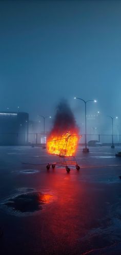 a shopping cart on fire in the middle of a parking lot