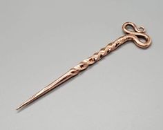 "This is a hand forged solid copper hair stick made in an old Viking/Celtic design. It makes a beautiful addition to any outfit or makes an awesome gift! Each one of these metal hair sticks are handmade on a coal forge and worked over an anvil by artist blacksmith Adam Rhein. No two pins are identical because they are individually handmade. Depending on your hair length and thickness, this stick will work great for several hairstyles. Includes: one hair stick. Check out some of my other awesome Coal Forge, Viking Hair, Celtic Design, Metal Hair, Copper Hair, Hair Stick, One Hair, Celtic Designs, Metallic Hair