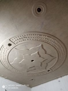 the ceiling is decorated with an intricate pattern and circular holes in the center that are cut out to look like flowers