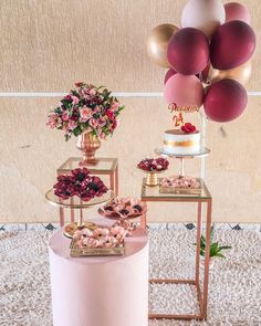 a table topped with cakes and desserts on top of a white carpeted floor