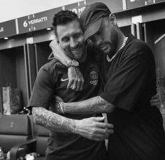 two men hugging each other in an airport