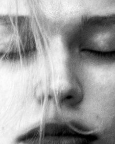 black and white photograph of a woman's face with her eyes close to the camera