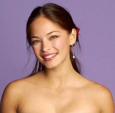 a beautiful young woman in a strapless bra smiling