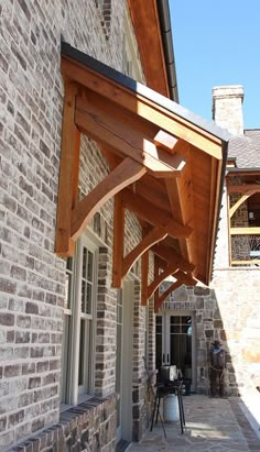 an outdoor covered patio area next to a brick building