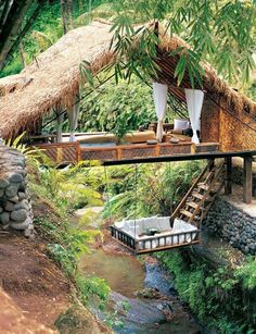 an outdoor area with a thatched roof and steps leading up to it