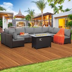 an outdoor living area with furniture on a wooden deck