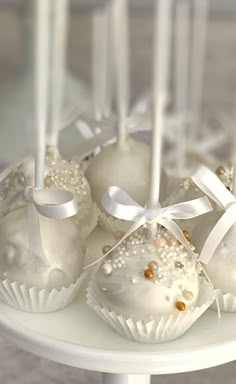 some white chocolates are on a cake plate