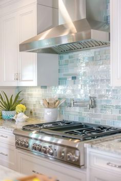 a stove top oven sitting inside of a kitchen next to white cabinets and counter tops