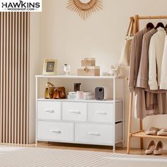 a white dresser sitting next to a closet filled with clothes