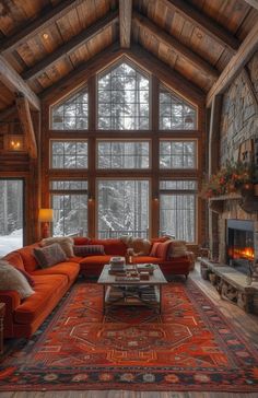 a living room filled with lots of furniture and a fire place in front of a large window