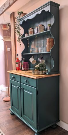 an old fashioned china cabinet painted green