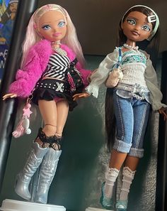 two dolls are standing next to each other