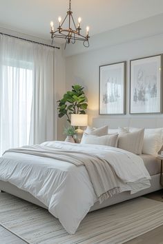 a bedroom with white linens and neutral decor