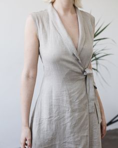 "A simply alluring and very feminine maxi dress in a color natural gray. Made from Lithuanian washed linen fabric that gives you a very nice appeal as well as a luxurious feel. FABRIC: 100% Softened Lithuanian Linen COLOR: Please choose the desired color from the side menu. STYLE: Sleeveless wrap dress with a belt to tie on the side. The fitted design also features a shawl collar and side pockets. SIZE CHART: 2 US/ 6 AU/ 34 EU: Bust 31.5\" (80 cm) , Waist 23\" (59 cm), Hips 35\" (88 cm) 4 US/ 8 Elegant Flax Linen Dress, Elegant Neutral Linen Maxi Dress, Chic Fitted Linen Wrap Dress, Elegant Linen Wrap Maxi Dress, Grey Wrap Dress, Dress With A Belt, Natural Linen Dress, Linen Wrap Dress, Sleeveless Linen Dress