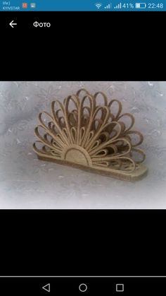 an image of a brooch that is made out of wood and has a peacock on it