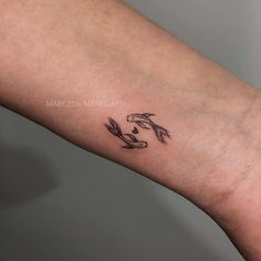 a tattoo on the arm of a person with a koi fish in it's hand