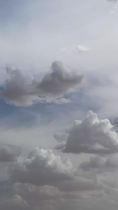 two airplanes flying in the sky on a cloudy day