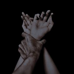 two hands reaching up to each other in the air with their arms extended towards one another