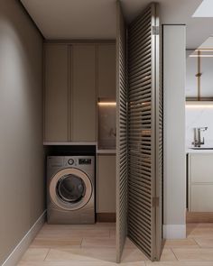 an open door to a washer and dryer in a room