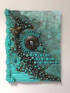 a piece of art that looks like it is made out of turquoise and brown beads