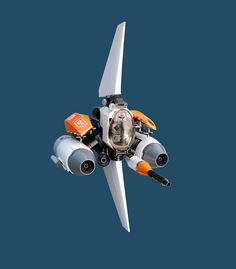 an orange and white airplane is flying in the air with its propeller extended to it's side