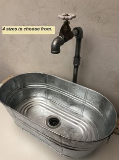 an old metal sink with faucet and water running from it