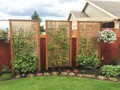 a wooden fence surrounded by green grass and flowers