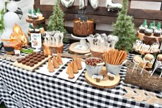 a table topped with lots of food and desserts