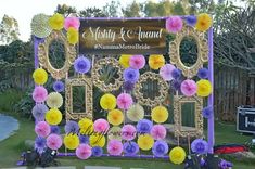 an outdoor ceremony with paper fans and flowers on the front wall, along with other decorations