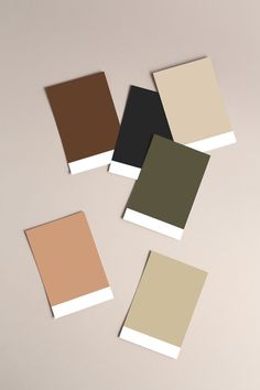 four different shades of brown, beige and white on a wall with the same color