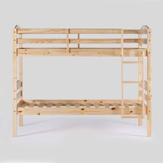 a wooden bunk bed sitting on top of a white floor