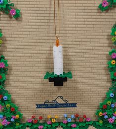 there is a clock made out of legos on the side of a brick wall